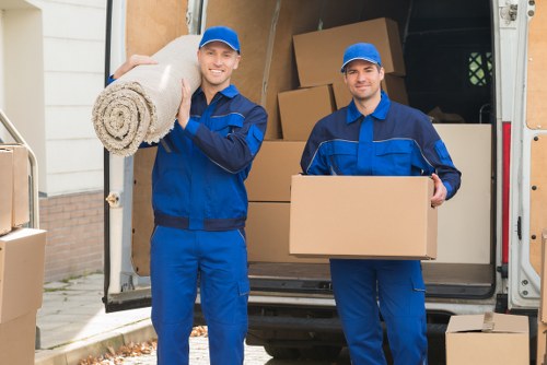 Person loading boxes into a van during a moving service