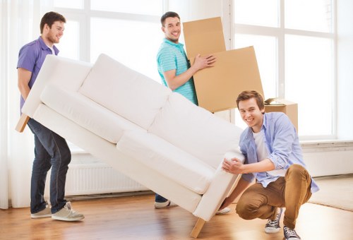 Packed boxes and furniture being loaded into a van