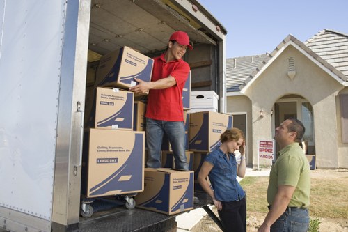 Movers carrying furniture through a home interior in Waterloo